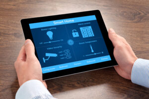 businessman holding a tablet computer with system smart house