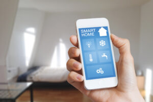 Smart home automation app on smartphone hold by female’s hand